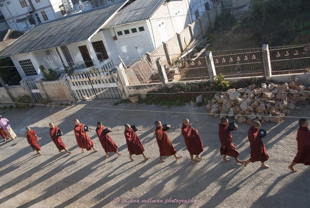 susana millman Buddhist travel photo of monks seeking offering myanmar