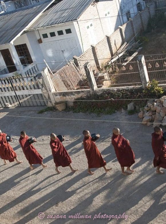 susana millman Buddhist travel photo of monks seeking offering myanmar